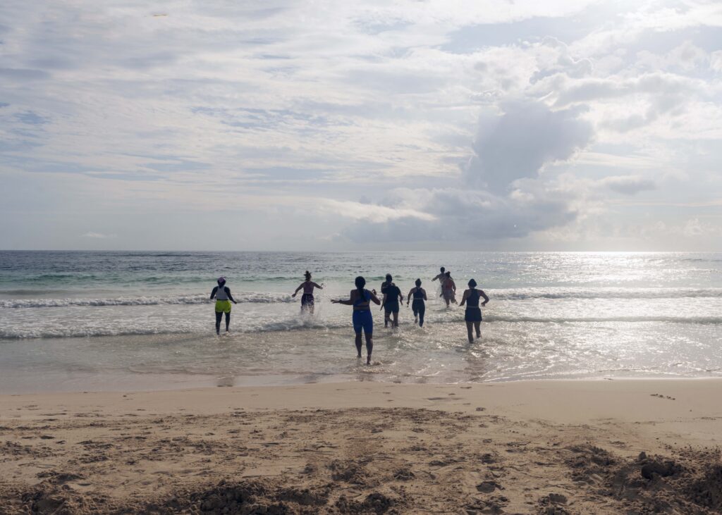 The connections don't feel forced because they aren't. They grow out of sunrise workouts on the beach, surfing waves you weren't sure you could handle, and boat days that turn into the best conversations of your life. 